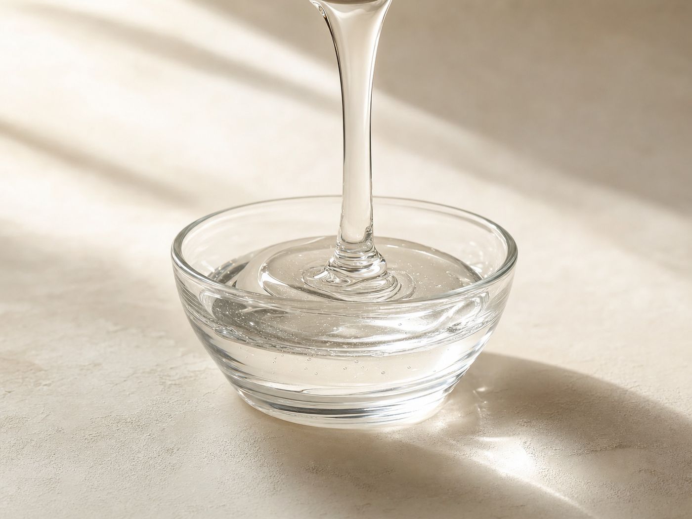 Clear viscous glucose syrup pouring